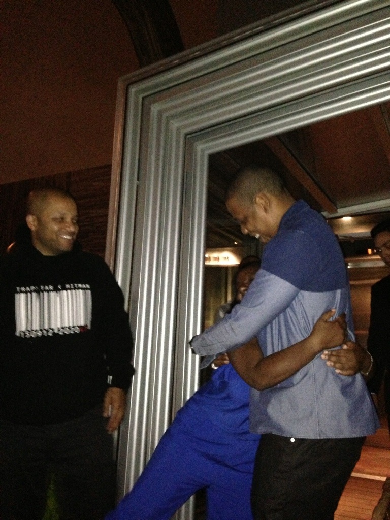 There's Jay Z, hugging on his friend at her birthday party. Nice to meet you, Jigga!